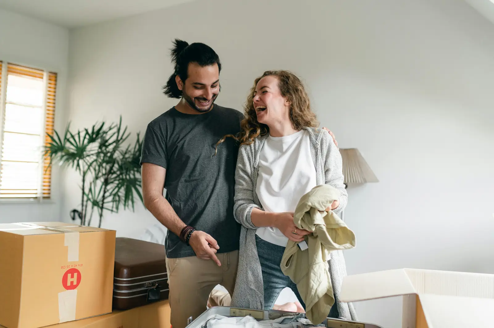 couple moving boxes renting vs buying 2025 blog straits row apartments baton rouge